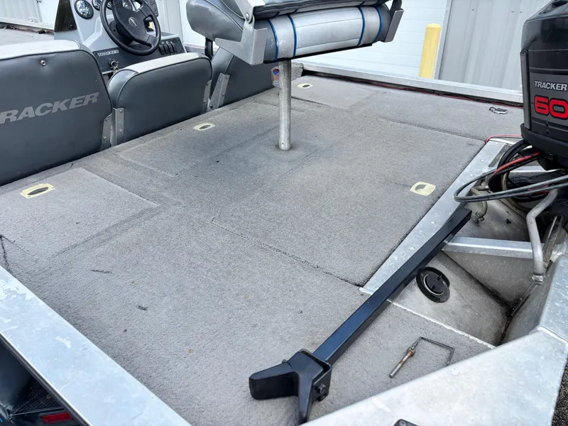 Slide: The Image of 1995 Bass Tracker Pro 18 boat interior with seating and motor, showcasing spacious deck layout. - 8