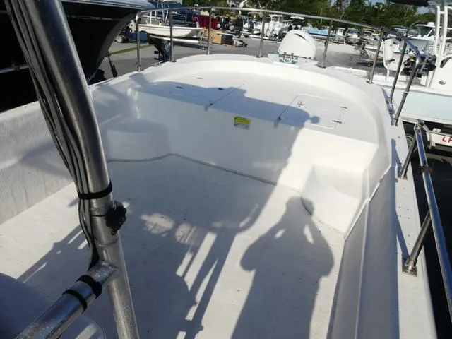 Slide: The Image of 2012 Carolina Skiff DLV Series 258 boat deck with railing, in a marina setting. - 11