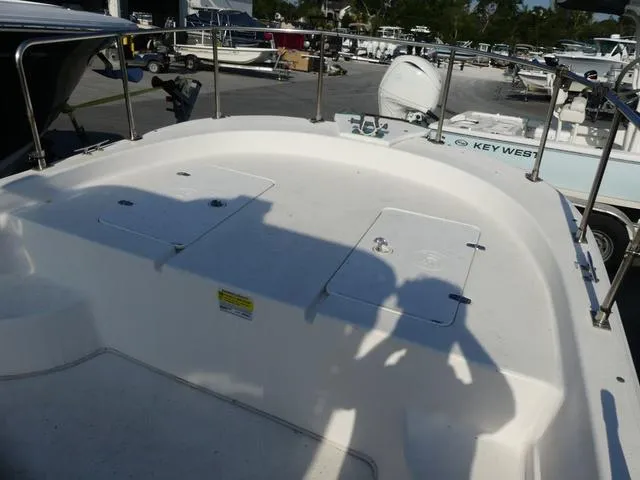 Slide: The Image of 2012 Carolina Skiff DLV Series 258 boat deck with storage compartments and railing. - 12