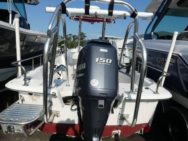 Slide: The Image of 2012 Carolina Skiff DLV Series 258 with Yamaha 150 engine, docked among other boats. - 5