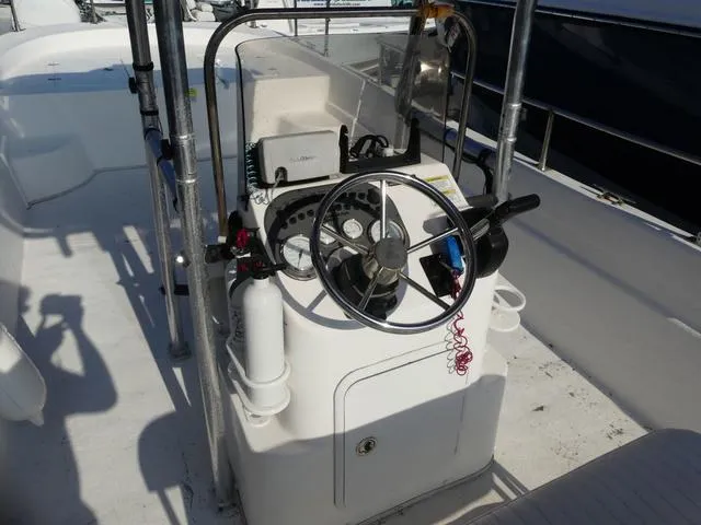 Slide: The Image of 2012 Carolina Skiff DLV Series 258 boat helm with steering wheel and controls. - 6