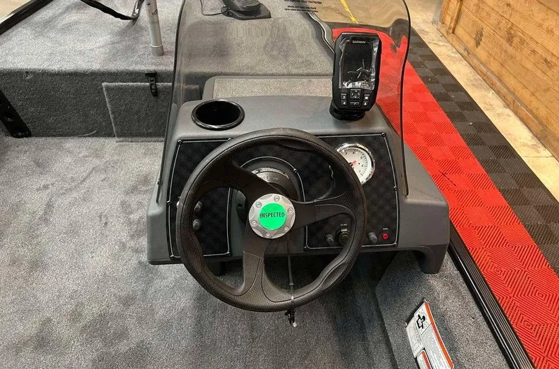Slide: The Image of 2025 Tracker BASS TRACKER® Classic XL boat dashboard with steering wheel and fish finder. - 5