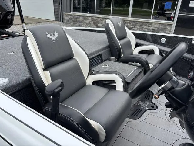Slide: The Image of 2020 Phoenix 920 Elite boat interior with black and white seats, steering wheel, and console. - 10