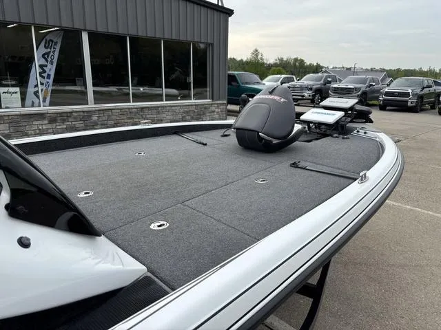 Slide: The Image of 2020 Phoenix 920 Elite boat with spacious deck, parked outside dealership. - 11
