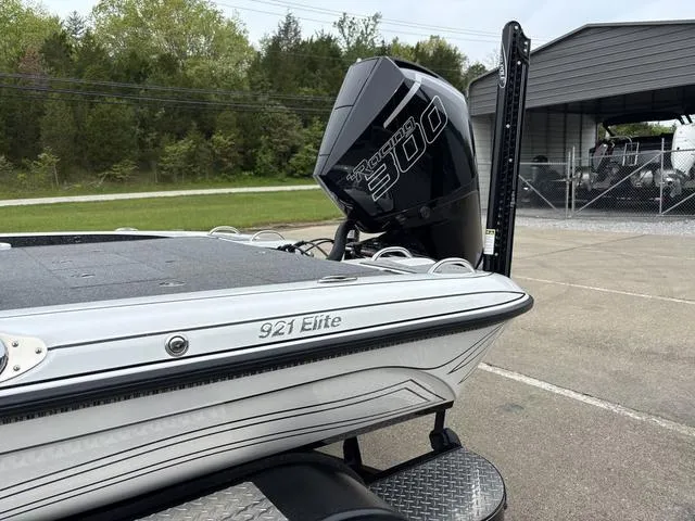 Slide: The Image of A 2020 Phoenix 920 Elite boat with a powerful motor, parked outdoors. - 16