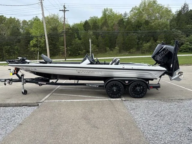 Slide: The Image of 2020 Phoenix 920 Elite boat on trailer, parked outdoors with trees in background. - 17