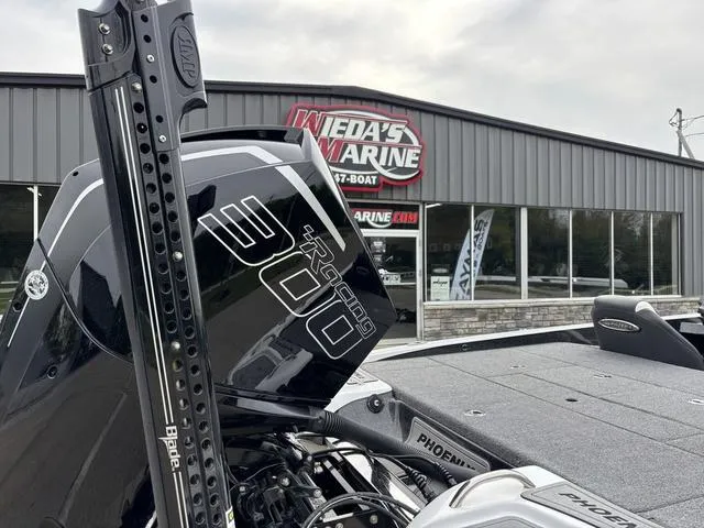 Slide: The Image of Phoenix 920 Elite boat with a powerful engine, displayed outside Wieda's Marine dealership. - 6