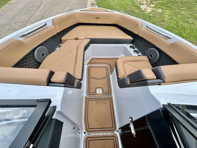 Slide: The Image of 2025 Cobalt R6 Surf boat interior with tan seating and modern design. - 10