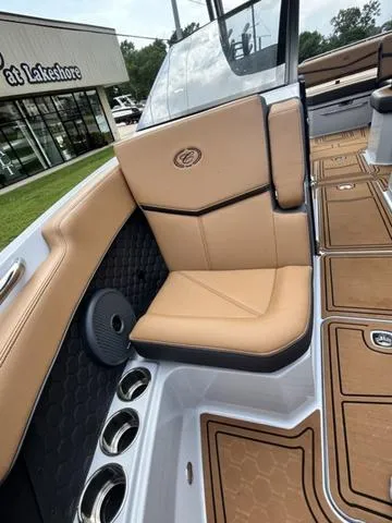 Slide: The Image of 2025 Cobalt R6 Surf boat interior with tan seating and cup holders. - 15