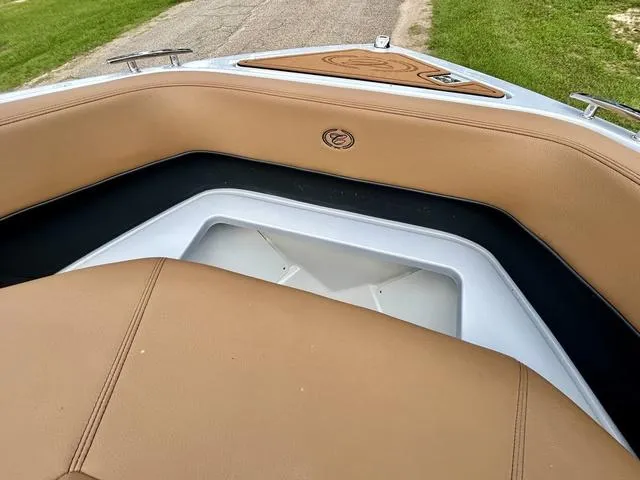 Slide: The Image of 2025 Cobalt R6 Surf boat interior with tan leather seating and storage compartment. - 19