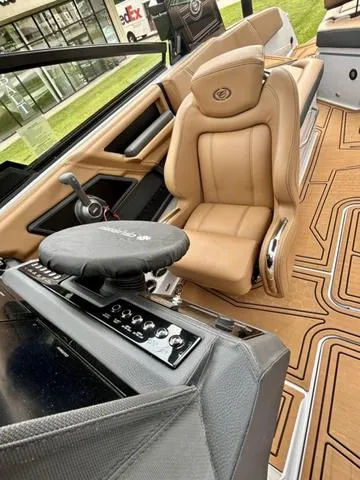 Slide: The Image of 2025 Cobalt R6 Surf boat interior with tan leather seating and modern controls. - 20