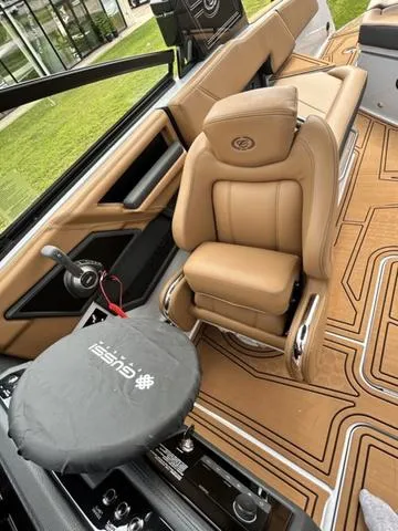 Slide: The Image of Luxurious interior of 2025 Cobalt R6 Surf boat with tan leather seating and modern controls. - 21