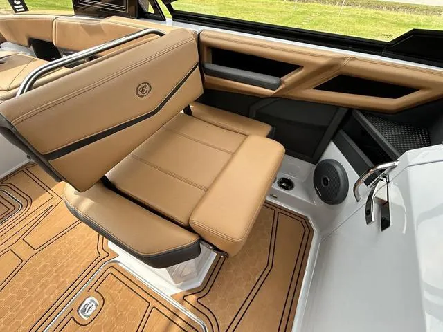 Slide: The Image of 2025 Cobalt R6 Surf boat interior with tan leather seating and modern design elements. - 26
