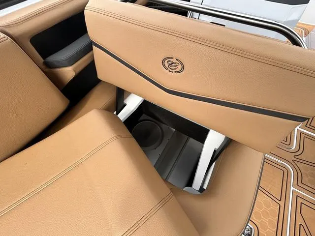 Slide: The Image of 2025 Cobalt R6 Surf boat interior with tan leather seating and storage compartment. - 34