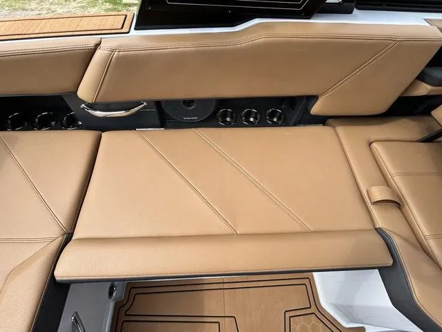 Slide: The Image of 2025 Cobalt R6 Surf boat interior with tan leather seating and sleek design. - 36