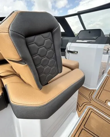 Slide: The Image of 2025 Cobalt R6 Surf boat interior with tan and gray seating, modern design. - 39