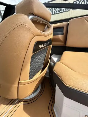 Slide: The Image of 2025 Cobalt R6 Surf boat interior with tan leather seating and stylish design. - 40