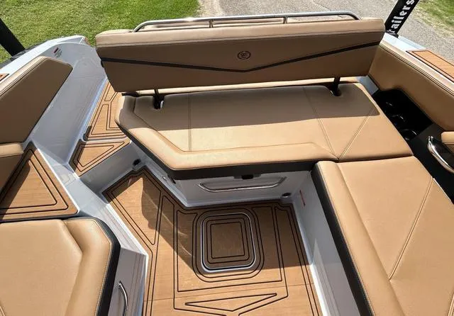 Slide: The Image of 2025 Cobalt R6 Surf boat interior with tan leather seating and teak flooring. - 48