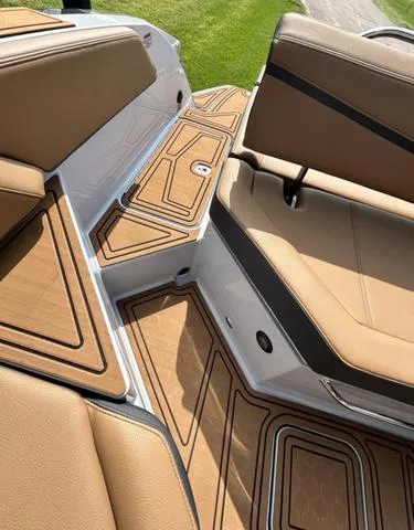 Slide: The Image of 2025 Cobalt R6 Surf boat interior with tan leather seats and stylish flooring design. - 49