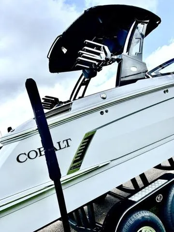 Slide: The Image of 2025 Cobalt R6 Surf boat on trailer, showcasing sleek design and modern features. - 5