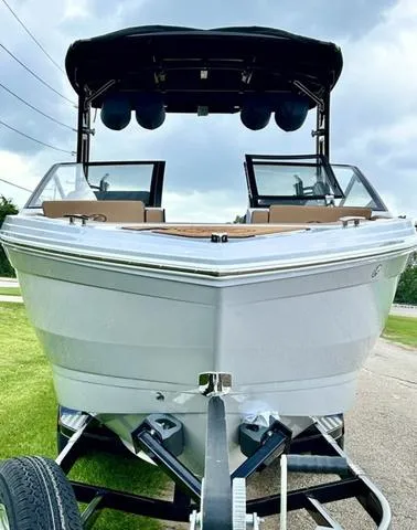 Slide: The Image of 2025 Cobalt R6 Surf boat on trailer, front view, overcast sky. - 6