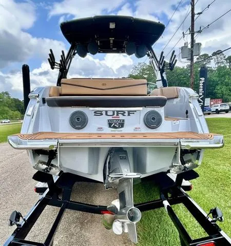 Slide: The Image of 2025 Cobalt R6 Surf boat, rear view, showcasing sleek design and powerful engine. - 7