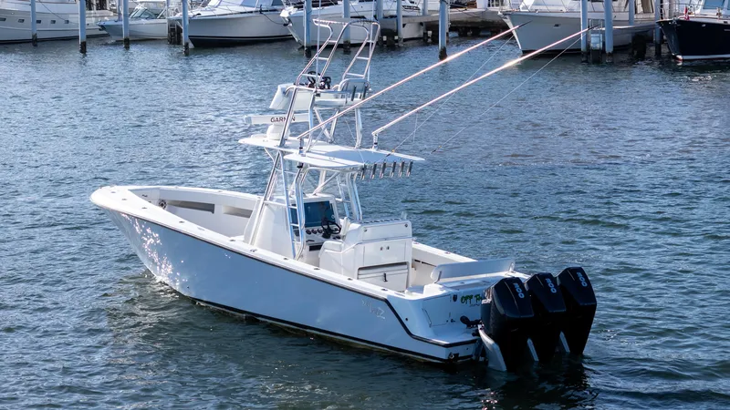 Slide: The Image of 2022 SeaVee 340Z boat with triple engines docked in marina. - 2