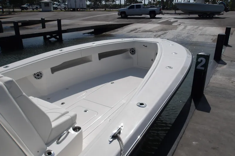 Slide: The Image of 2022 SeaVee 340Z boat at dock, showcasing spacious deck and seating area. - 5