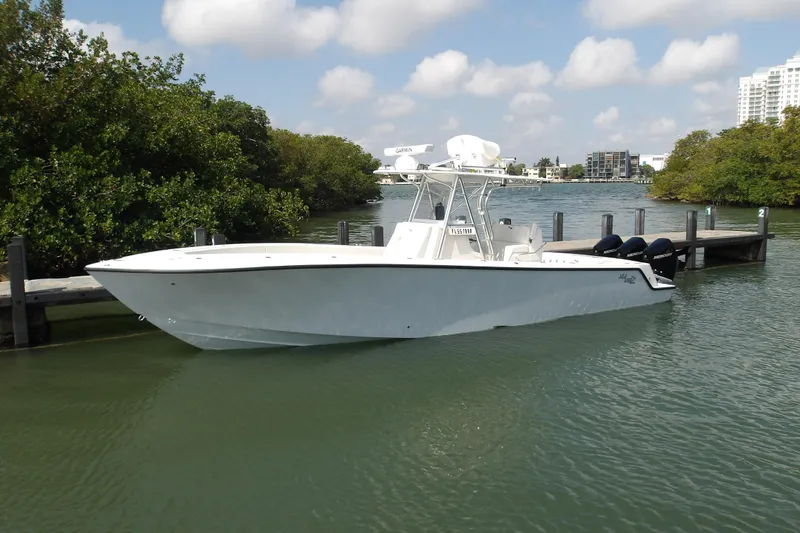 Slide: The Image of 2022 SeaVee 340Z boat docked in a serene waterfront setting. - 7