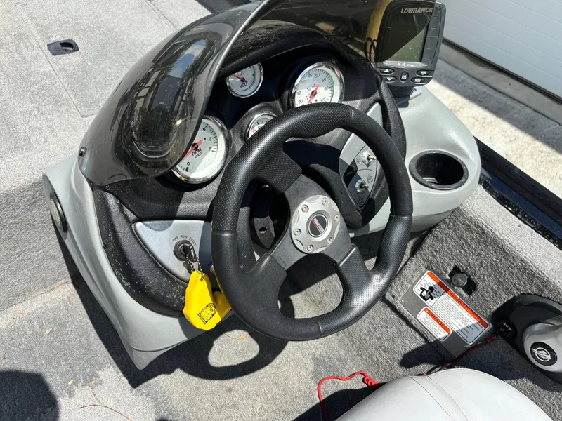 Slide: The Image of Steering console of 2012 Bass Tracker PRO TEAM 190 boat with gauges and fish finder. - 7