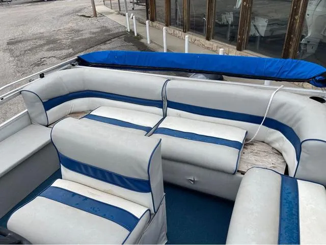 Slide: The Image of 1995 Sun Tracker BASS BUGGY 18 pontoon boat with blue and white seating. - 11