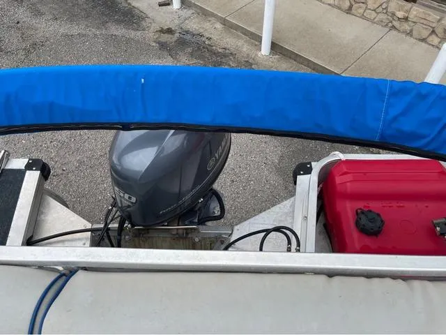 Slide: The Image of 1995 Sun Tracker BASS BUGGY 18 with outboard motor and red fuel tank. - 13