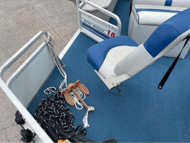 Slide: The Image of 1995 Sun Tracker BASS BUGGY 18 boat interior with blue seating and anchor rope. - 7