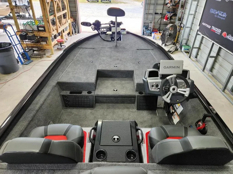 Slide: The Image of 2025 Tracker SAVAGE™ 215 boat interior with Garmin system, dual seats, and spacious deck. - 10