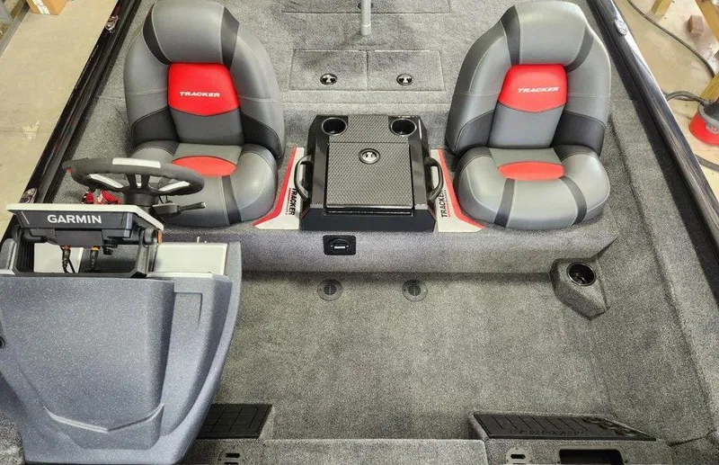 Slide: The Image of 2025 Tracker SAVAGE™ 215 boat interior with dual seats and Garmin navigation system. - 12