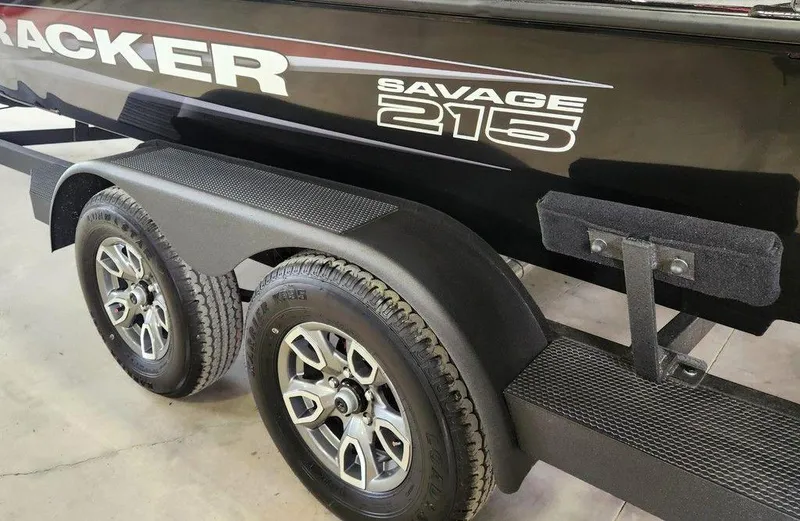 Slide: The Image of 2025 Tracker SAVAGE™ 215 boat trailer with dual wheels and sleek black design. - 13