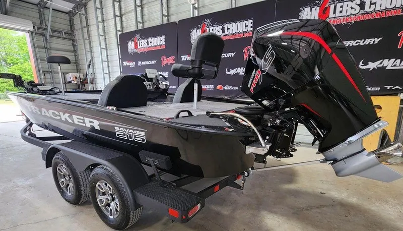 Slide: The Image of 2025 Tracker SAVAGE™ 215 boat in showroom, featuring sleek design and powerful engine. - 3