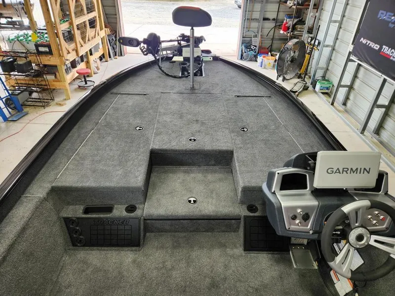 Slide: The Image of 2025 Tracker SAVAGE™ 215 boat interior with Garmin system in a garage setting. - 8
