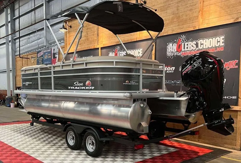 Slide: The Image of 2025 Sun Tracker PARTY BARGE® 20 DLX pontoon boat displayed indoors. - 3