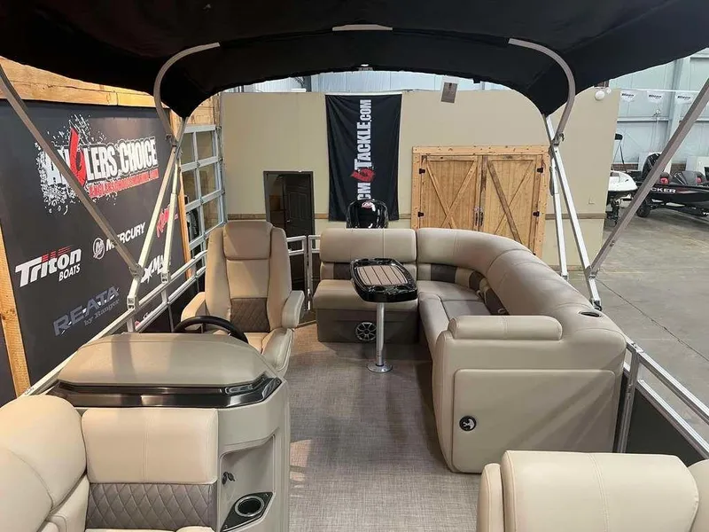 Slide: The Image of 2025 Sun Tracker PARTY BARGE® 20 DLX pontoon boat interior with seating and table. - 5