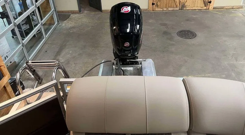 Slide: The Image of 2025 Sun Tracker PARTY BARGE® 20 DLX pontoon boat with motor in a garage setting. - 7