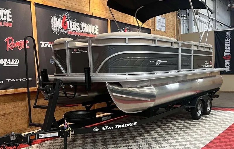 Slide: The Image of 2025 Sun Tracker PARTY BARGE® 20 DLX pontoon boat on display in showroom. - 8