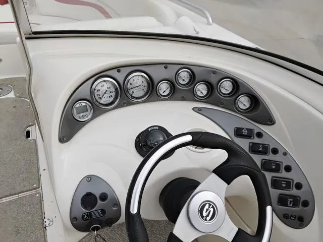 Slide: The Image of 2004 Sylvan 2240 Deck Boat dashboard with steering wheel and instrument panel. - 10