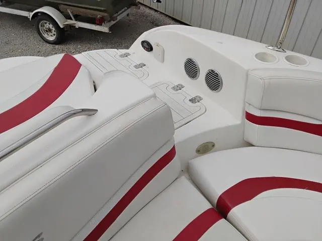 Slide: The Image of 2004 Sylvan 2240 Deck Boat interior with white and red seating. - 13
