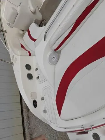 Slide: The Image of 2004 Sylvan 2240 Deck Boat interior with red and white seating. - 18