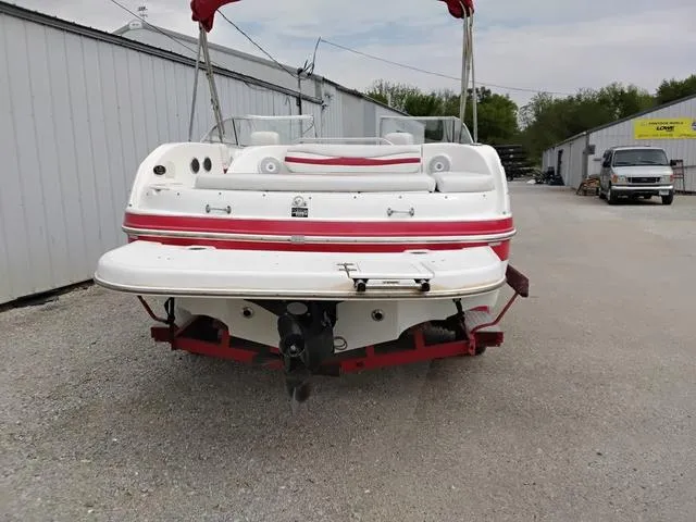 Slide: The Image of 2004 Sylvan 2240 Deck Boat, red and white, parked outdoors. - 4