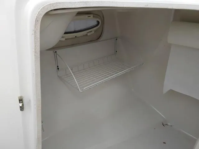 Slide: The Image of Interior storage space of a 2004 Sylvan 2240 Deck Boat with wire shelf. - 8