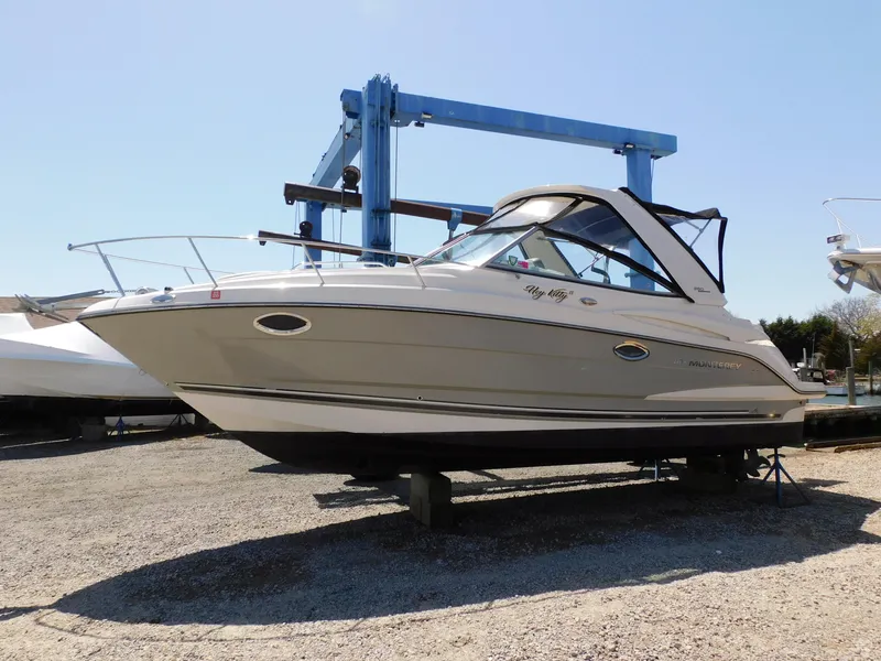 Slide: The Image of 2011 Monterey 260 SCR boat on dry dock, side view, clear sky background. - 0