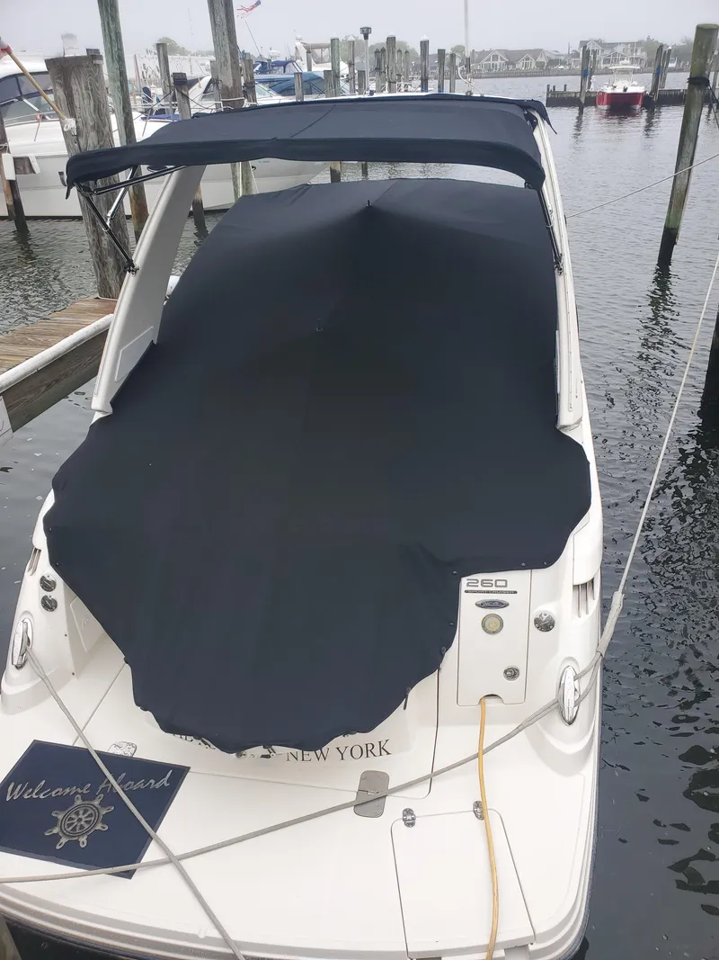 Slide: The Image of 2011 Monterey 260 SCR boat docked with cover, marina background. - 22