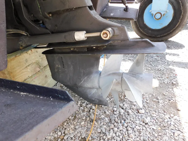 Slide: The Image of 2011 Monterey 260 SCR boat propeller and drive system on gravel surface. - 23